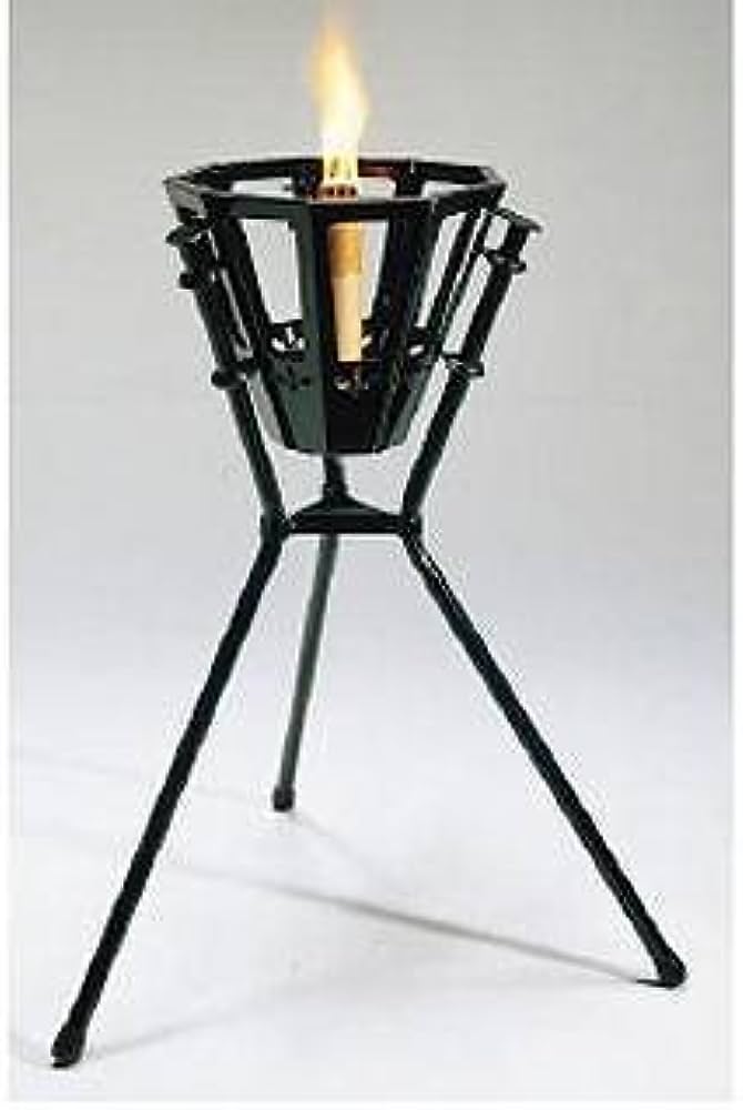Black metal bent into a basket shape with three legs holding a thin white candle.