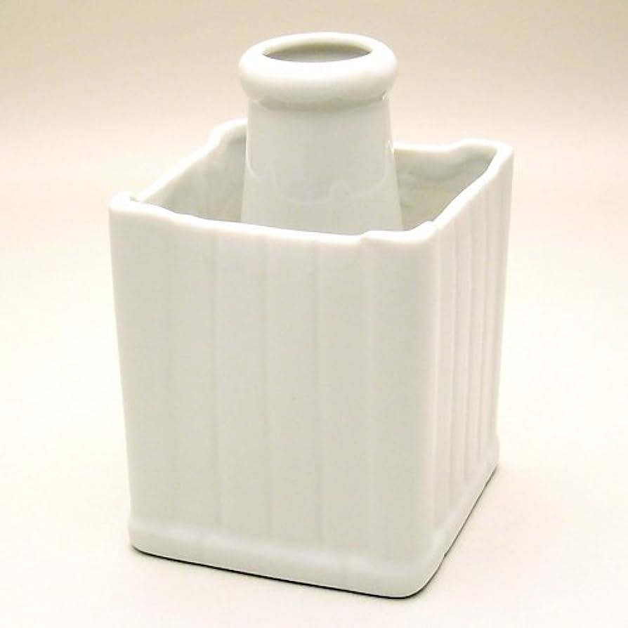 A white ceramic vase inside of an attached ceramic square box.